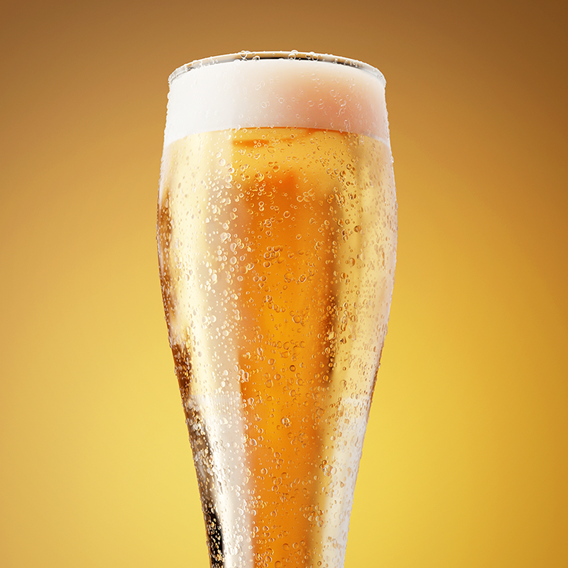 A glass of beer with condensation droplets