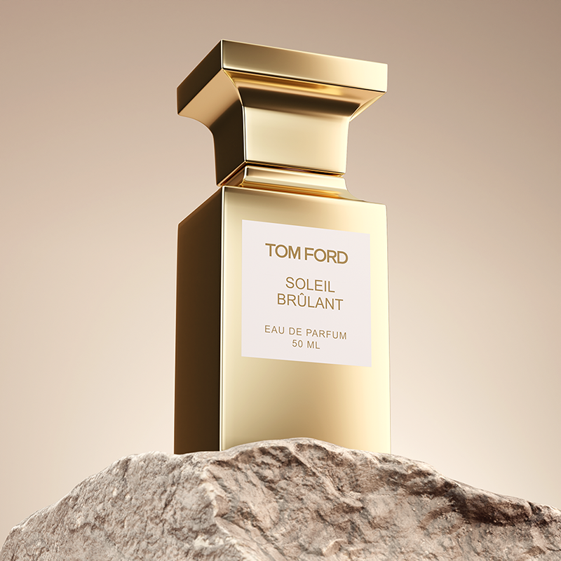 A bottle of Tom Ford perfume placed on a golden rock